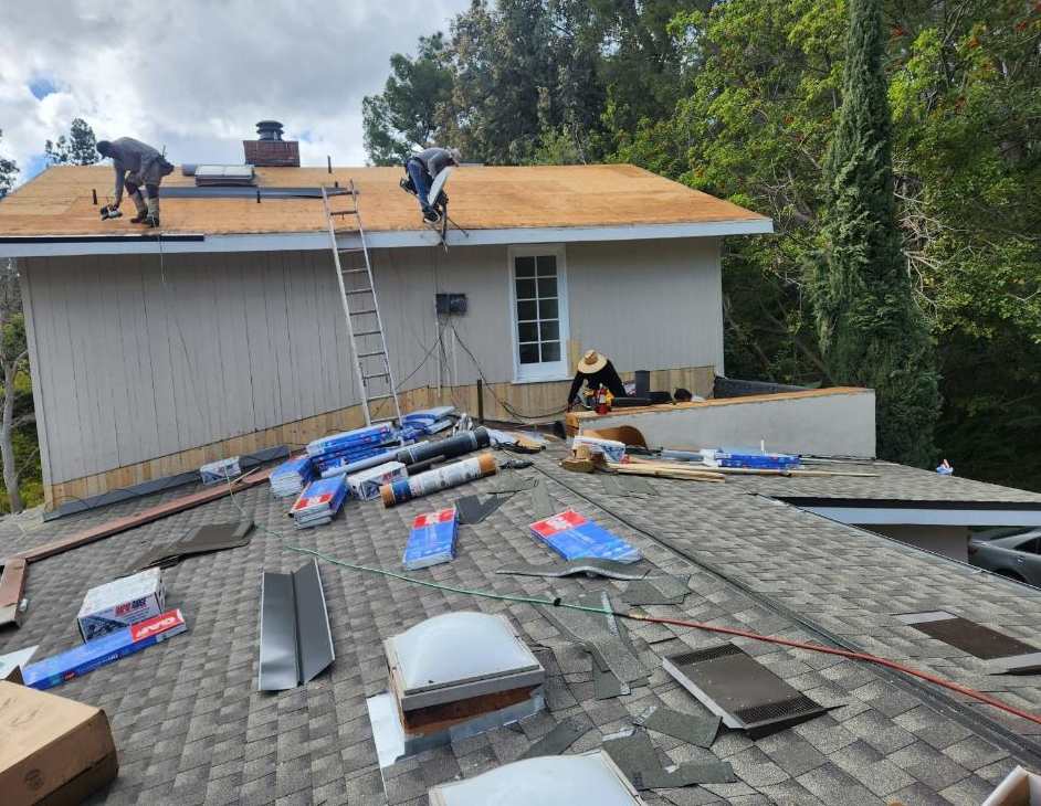 Active roofing work across a broad roof deck.