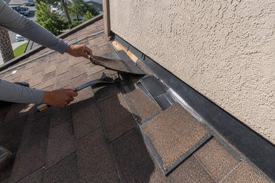 Flashing repair work at a roof transition.