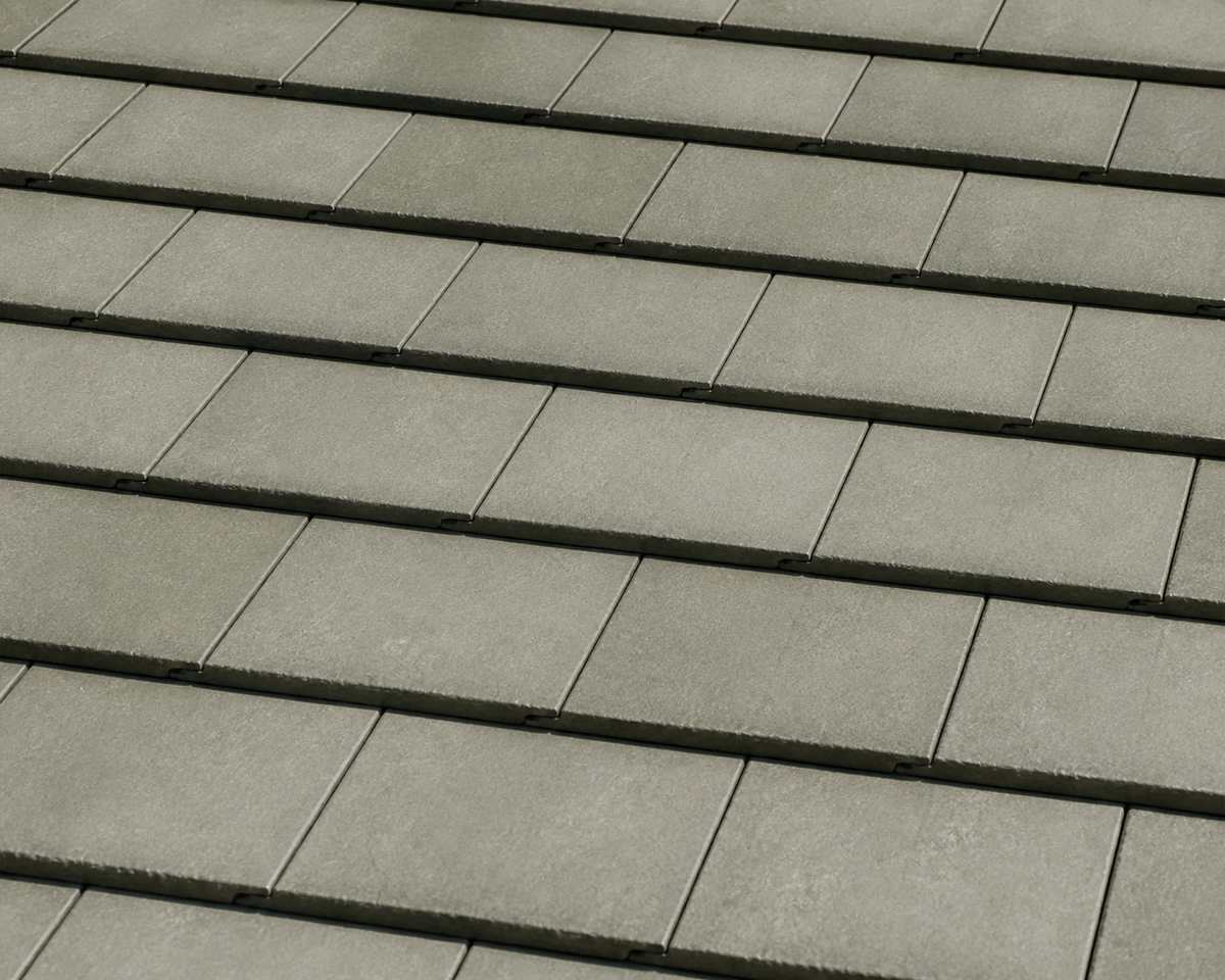 Sage-gray flat tiles across a finished roof field.