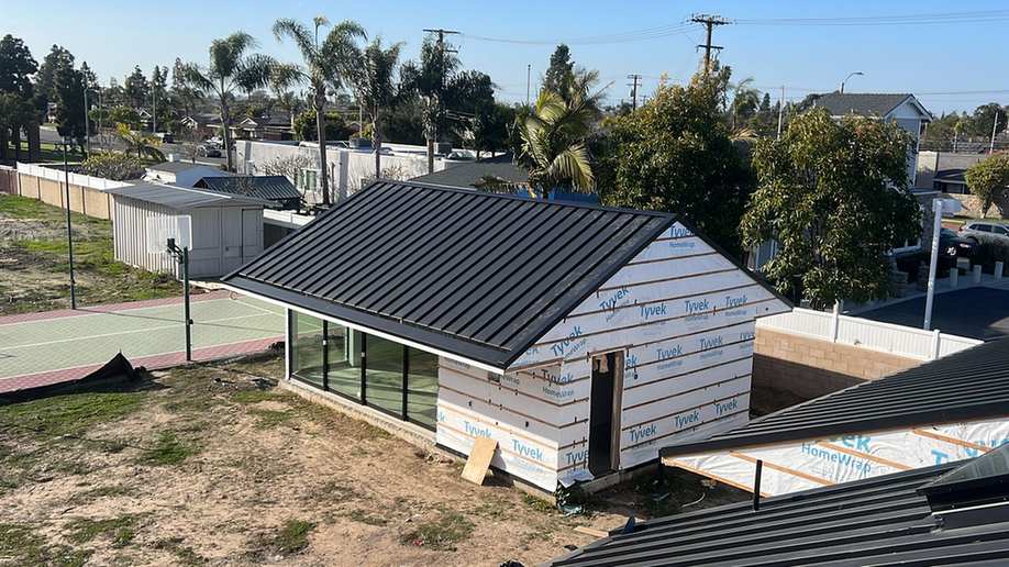 Finished standing-seam metal roof on a residential structure.
