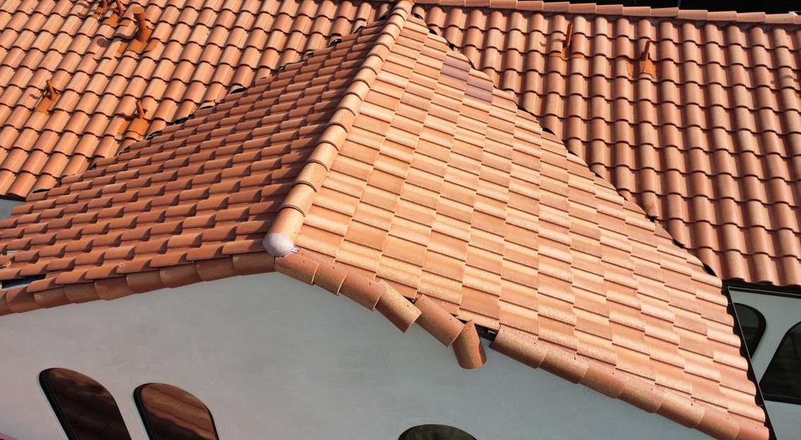 Elevated view of a multi-plane terracotta tile roof.