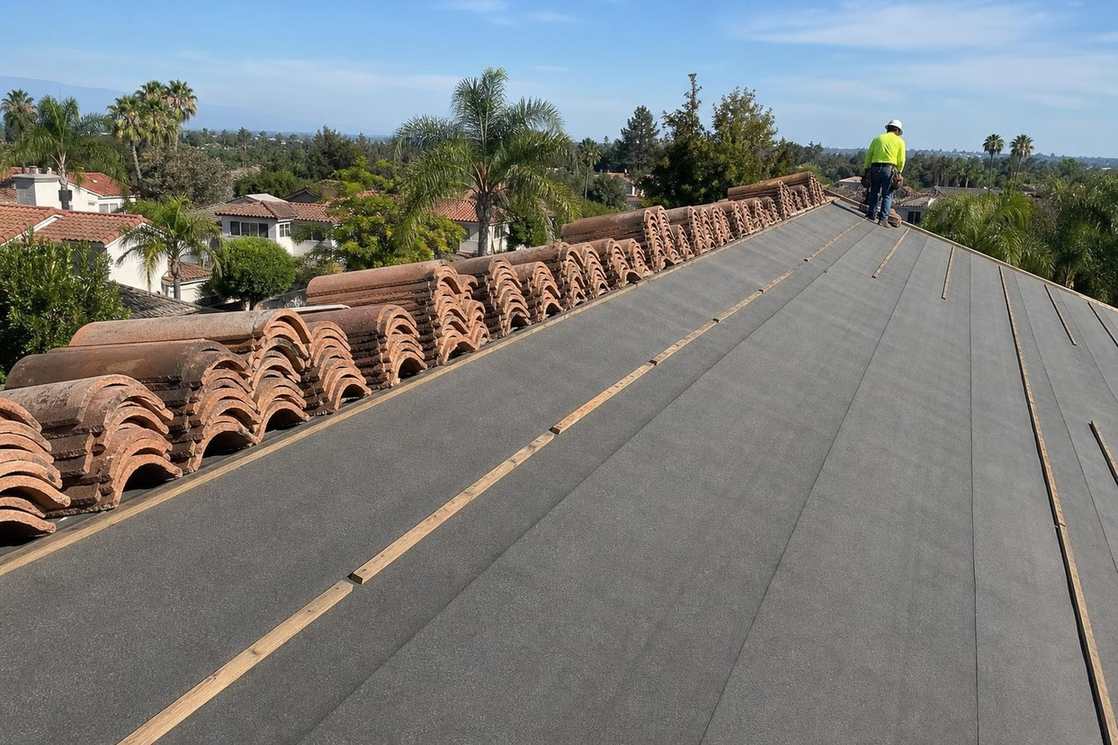 Roof underlayment exposed during tile roofing work.